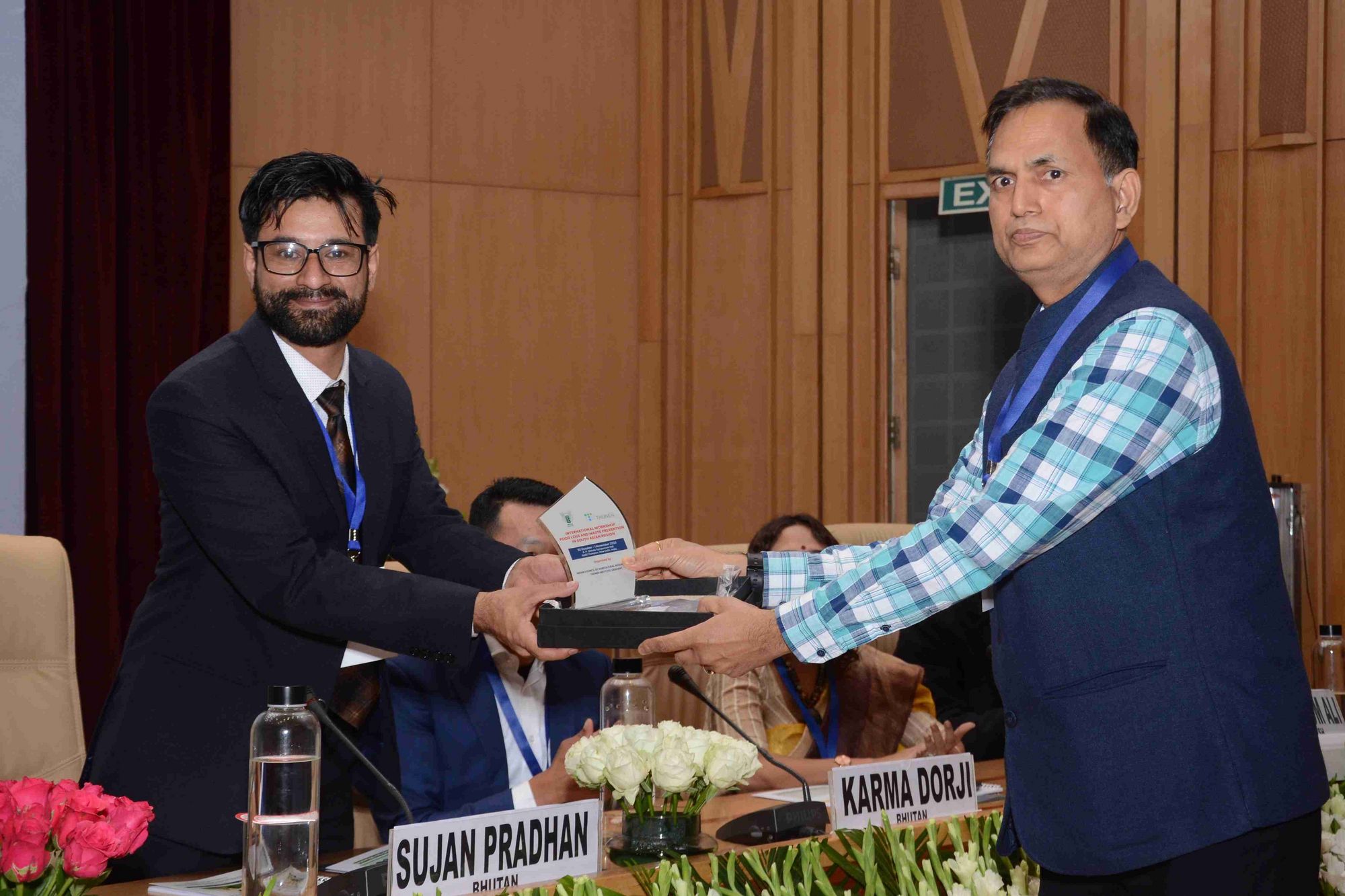 Mr. Sujan Pradhan, Chief Postproduction Officer from National Post Harvest Centre Bhutan, serving as co-chair receives his memento after the session by Dr K P Singh, Assistant Director General Indian Council of Agricultural Research.