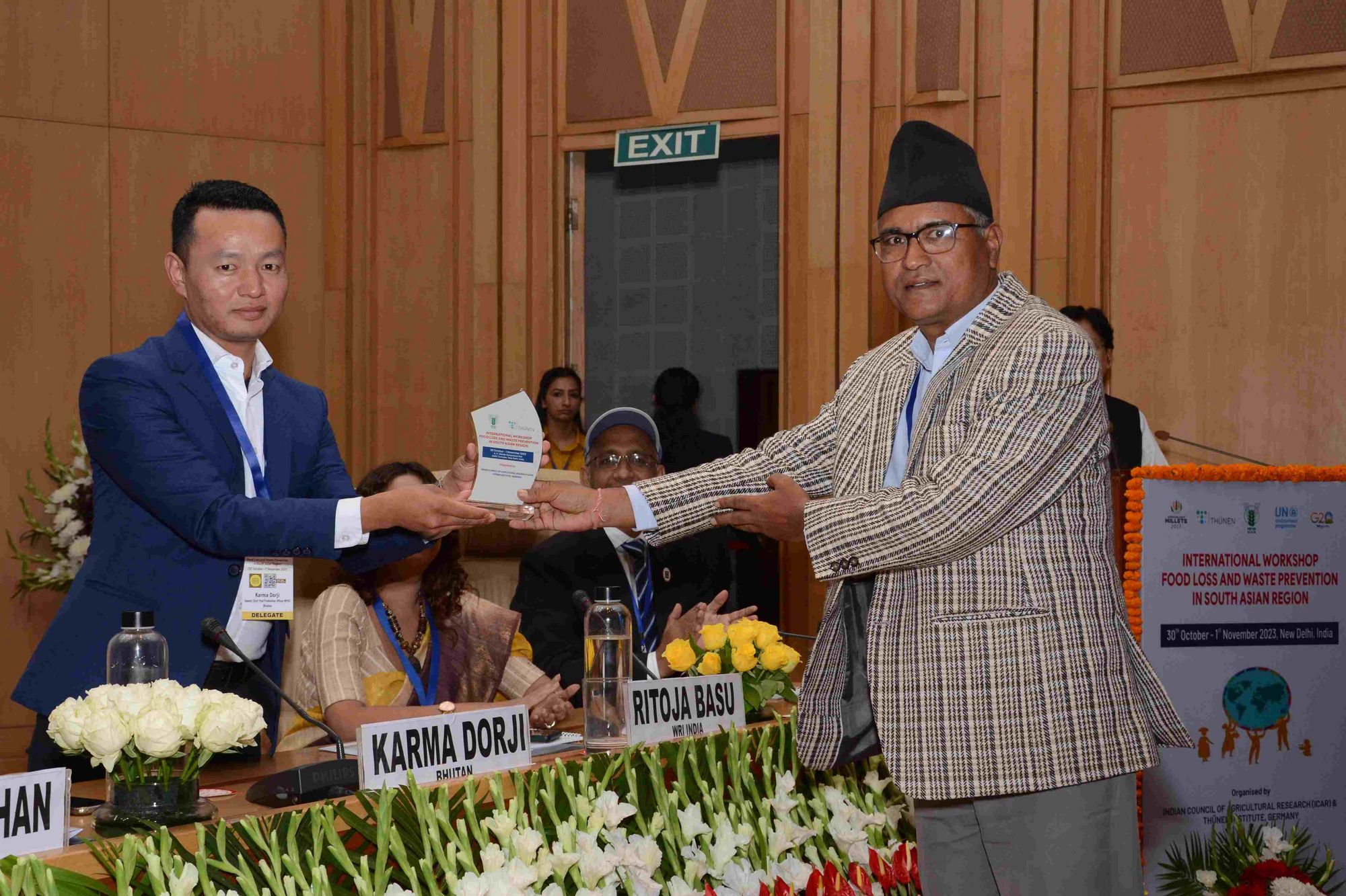 Mr Karma Dorji, Dy Chief Post Production Officer at National Post Harvest Centre Bhutan, receives his memento after his presentation by Dr. Pradeep Raj Rokaya from Nepal.