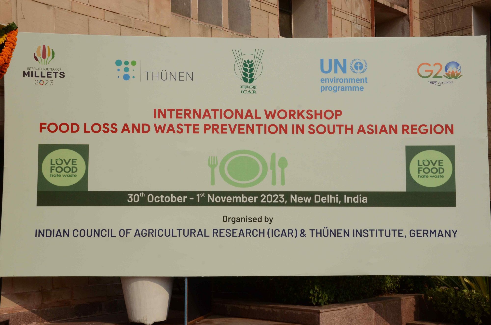 The banner of the International Workshop Food Loss and Waste Prevention in South Asian Region located at the venue entrance.