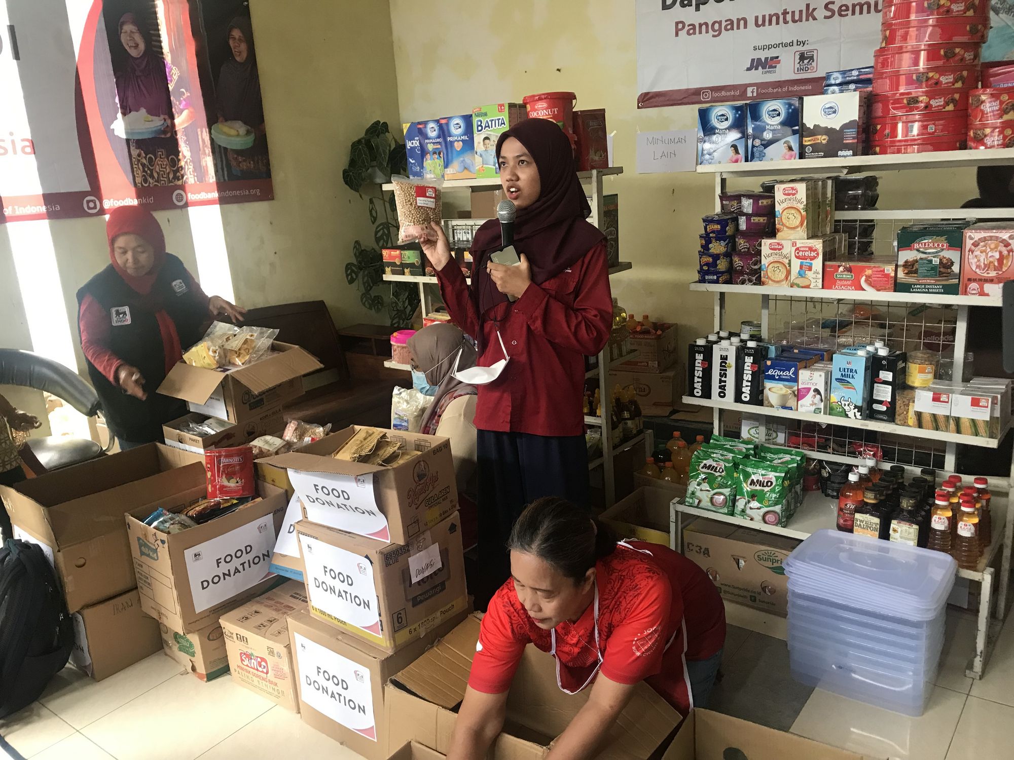 Food Bank staff members demonstrate how donations are sorted for further distribution.