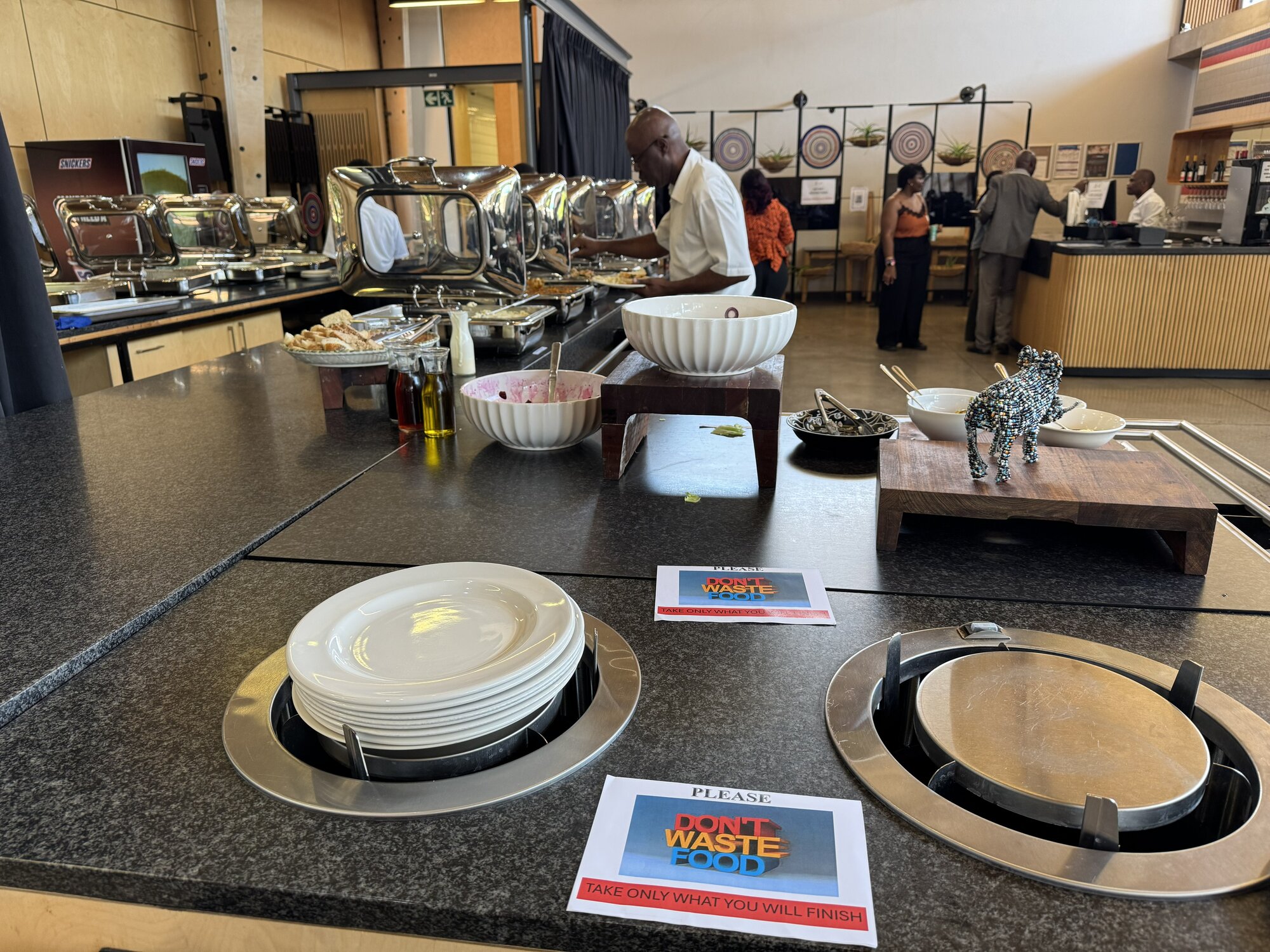 Lunch buffet at the workshop with "do not waste food" signs